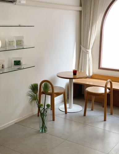 a dining room with a table and two chairs at Evergreen Cafe and Hotel in Chiang Mai