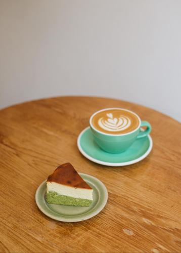 a piece of cake and a cup of coffee on a table at Evergreen Cafe and Hotel in Chiang Mai