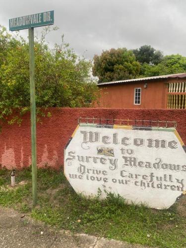 a sign that says welcome to surrey international ambulancegencygencygencygencygencyagency at Portmore - Private AFFORDABLE Bedroom - FAN ONLY with Pay Per Use AC OR - FULL AC Choose Standard room or Superior King Accordingly in Portmore