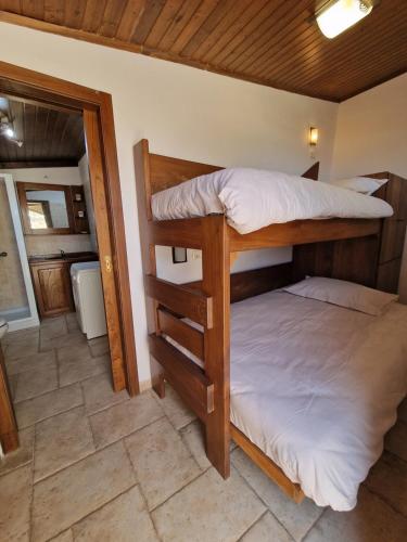 two bunk beds in a room with a bathroom at Oliventu - Tra gli ulivi sul mare in Leuca