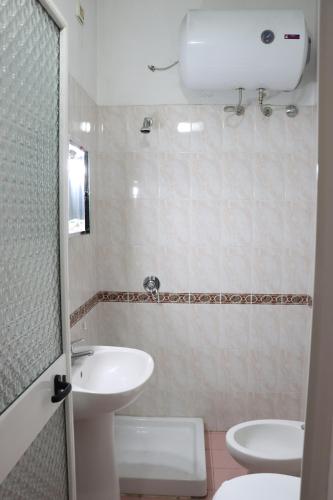 a bathroom with a sink and a toilet at ~Villa Gloria~ in Durrës