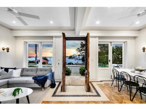 a living room with a couch and a table at Tusan Villa Little Manly in Sydney