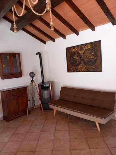 a living room with a couch and a tv at Mansarda con terrazza a Diano in Diano Castello