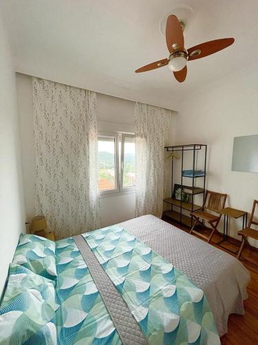 a bedroom with a bed and a ceiling fan at Rose House in Kavála