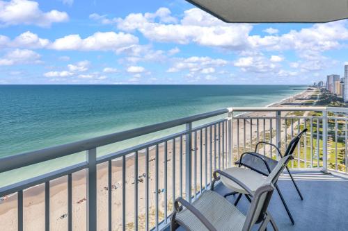 a chair on a balcony overlooking the beach at Carolinian Corner Gem Views! in Myrtle Beach