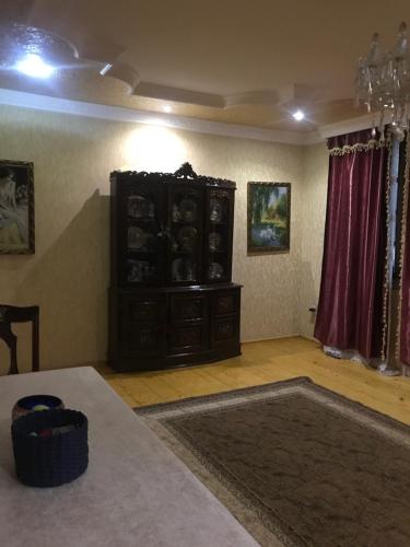 a living room with a dresser in the corner of a room at gaydi in Gori