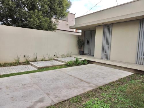 a house with a concrete walkway in front of it at La Casita Amaia in Yerba Buena