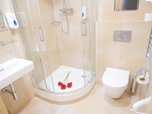 a bathroom with a shower with a toilet and a sink at Abitohotel in Prague