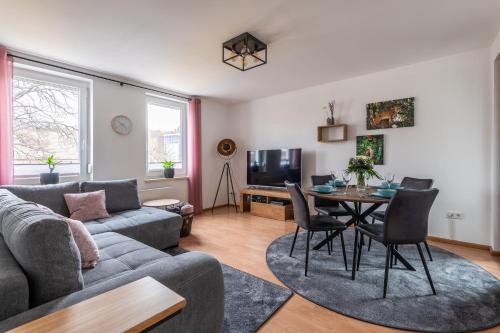 uma sala de estar com um sofá e uma mesa em Neu! Inklusive Bettwäsche, Handtücher und vieles mehr - Perfekt für Urlaub, Familie und Workation - Boxspringbetten und Arbeitsplatz em Bad Harzburg