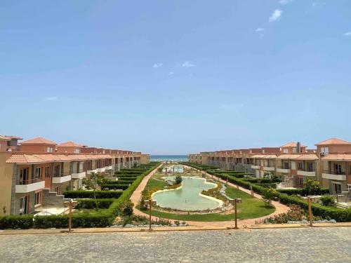 a view of a courtyard of a building with a fountain at Sun Mirror Chalet El Sokhna in Ain Sokhna