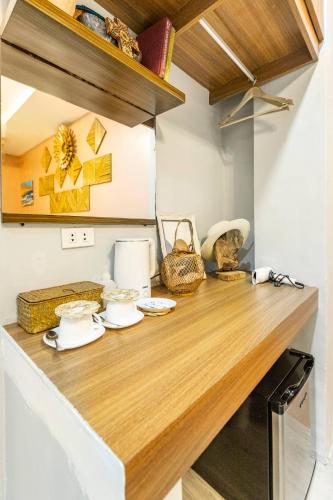 a kitchen with a wooden counter top in a room at Rain Airport Bed and Breakfast in Manila