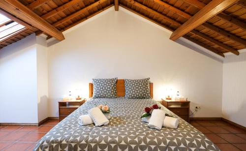 a bedroom with a large bed with flowers on it at Kayak Azores in Ponta Delgada