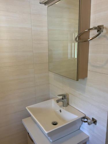 a bathroom with a white sink and a mirror at G Gold BNB in Fourways