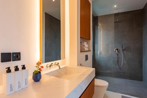 a bathroom with a sink and a shower at Aquamarine Villa 1 Canggu in Canggu