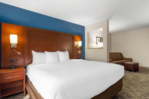a large white bed in a hotel room at Comfort Suites Atlanta Airport in Forest Park