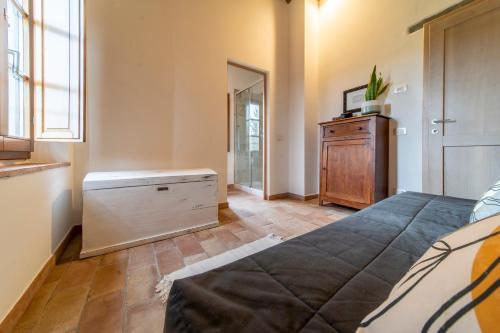 Schlafzimmer mit einem Bett, einer Kommode und einem Spiegel in der Unterkunft Fornace di Bonazza in Tavarnelle in Val di Pesa