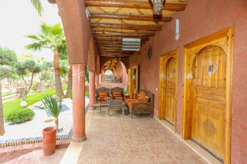 a porch of a house with a table and chairs at Chez Mamouchthka in Ourika