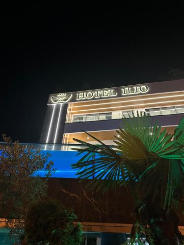 a hotel with a sign on the side of a building at Ilio Boutique Hotel in Ksamil
