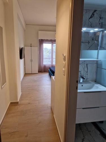 a kitchen with a sink and a counter top at Above Apartments near the Airport in Artemida