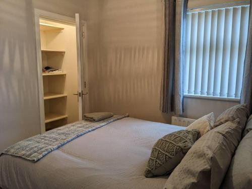 a small bedroom with a bed with a window at Entire House with Mountain view in Moneymore