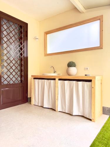 a bathroom with a sink and a window at La casa di Apollo in Acireale