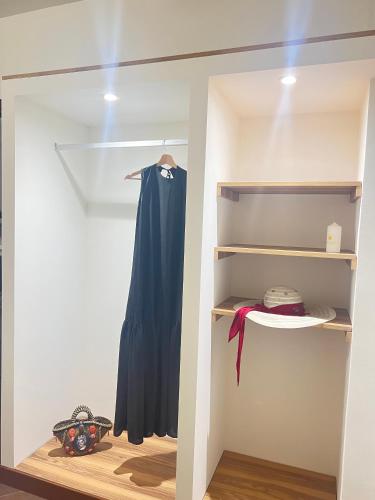 a closet with a blue dress on a shelf at La casa di Apollo in Acireale