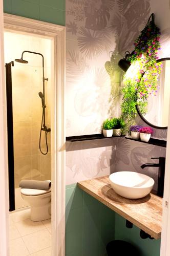 a bathroom with a sink and a toilet and a mirror at JARAUTARESORT in Pamplona