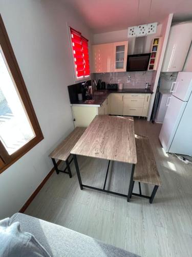 a kitchen with two wooden tables and a refrigerator at Home DisneyLand Paris avec Parking wifi in Lagny
