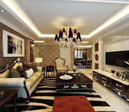 a large living room with a couch and a tv at شاليه دوبلكس فالجونه للايجار in Hurghada