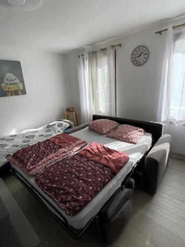 a bed in a bedroom with two pillows on it at Home DisneyLand Paris avec Parking wifi in Lagny