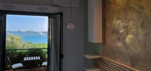 a room with a window with a view of the ocean at Katarina Apartments Kefalonia - Sea View in Kefallonia