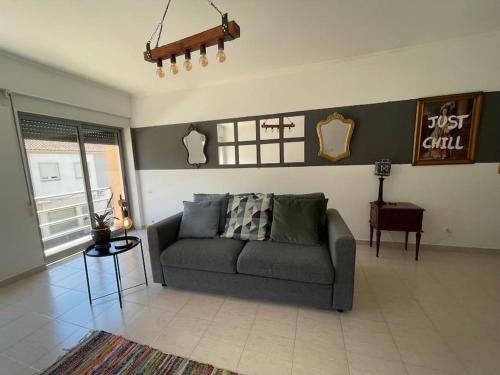 a living room with a couch and a table at House of Grace Charm Apartment in Santana