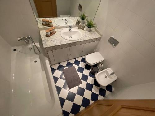 a bathroom with a sink and a toilet and a shower at House of Grace Charm Apartment in Santana