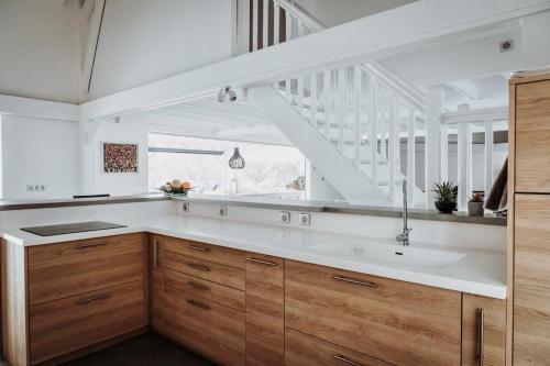 a kitchen with a sink and a staircase at Sunset Bay - villa de luxe avec magnifique vue Ilets Pigeon in Bouillante