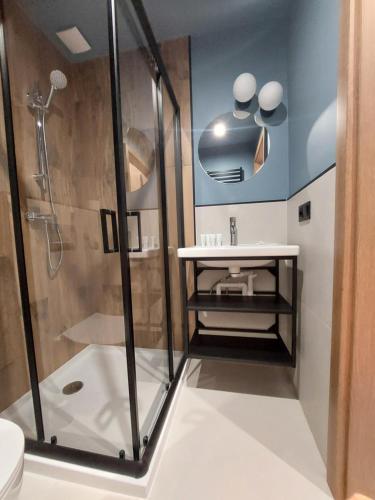 a bathroom with a shower and a sink at Apartamenty Neptun in Świnoujście