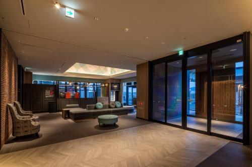 a living room with a couch and a table at Tokyu Stay Hakodate Asaichi Akarinoyu in Hakodate