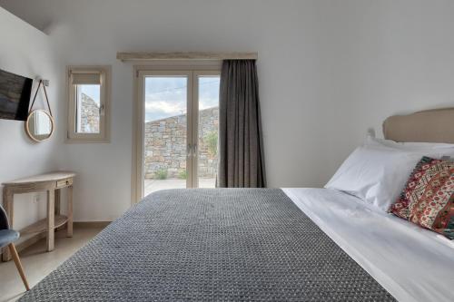 Un dormitorio con una cama grande y una ventana en Villa Cataleya 3 PRIVATE POOL, en Fanari