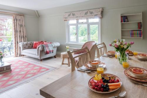 a living room with a table with food on it at 2 St Elmo Lodge in Salcombe