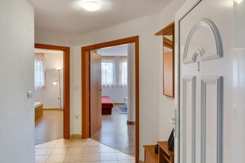 a hallway with a door leading to a living room at Villa Mirela in Petrcane