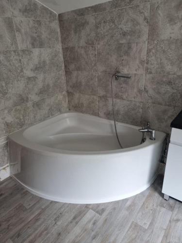 a large white bath tub in a bathroom at Margate Town House in Kent