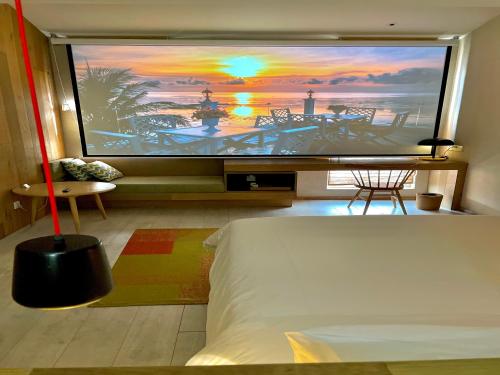 einen Großbild-TV in einem Zimmer mit einem Bett in der Unterkunft EBO Hotel Zijin gang Asian Games Park Store Zhejiang university in Hangzhou