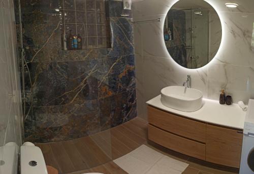 a bathroom with a sink and a mirror at limonchello 2 in Kalamata