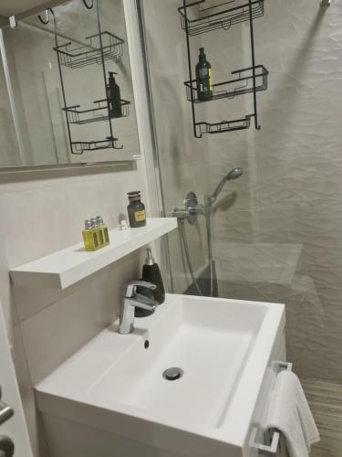 a bathroom with a white sink and a mirror at BRAND NEW lovely apartment Bella in Dubrovnik