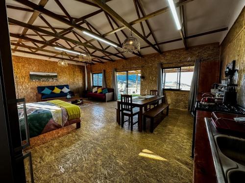 a bedroom with a bed and a desk in a room at Gecko Rock Private Nature Reserve in Goedgemond