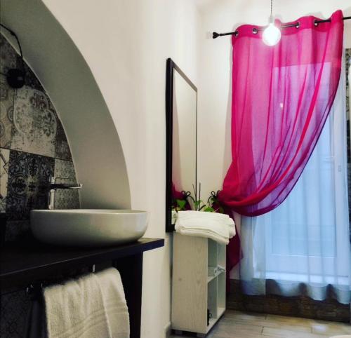 a bathroom with a sink and a mirror at Prima Stella Tourist Rooms in Minturno