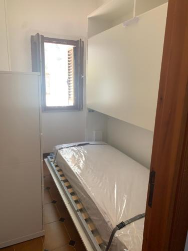 a room with a bed in a room with a window at Mari-Mare Home in Rodi Garganico