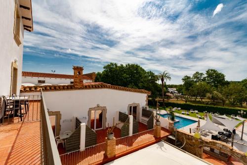 a villa with a swimming pool and a deck at Hotel Castell Blanc in Empuriabrava
