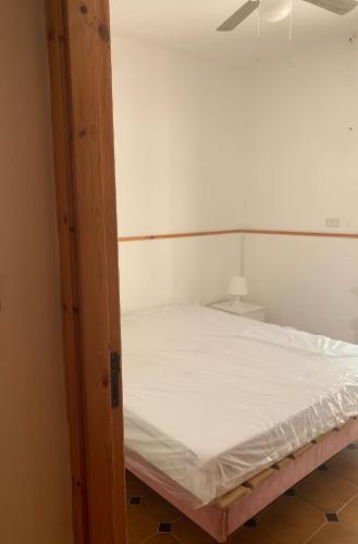 a bed in a room with an open door at Mari-Mare Home in Rodi Garganico