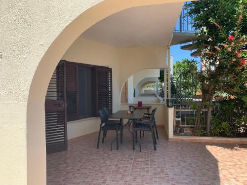 a patio with a table and chairs in a house at Mari-Mare Home in Rodi Garganico