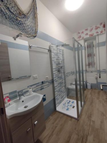 a bathroom with a shower and a sink and a toilet at Blue Dream in Gaeta